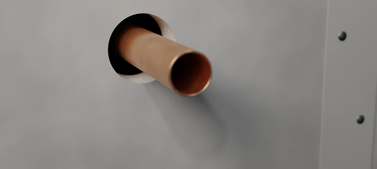 Before: the 52 mm round opening with the copper pipe through the two-layer board wall